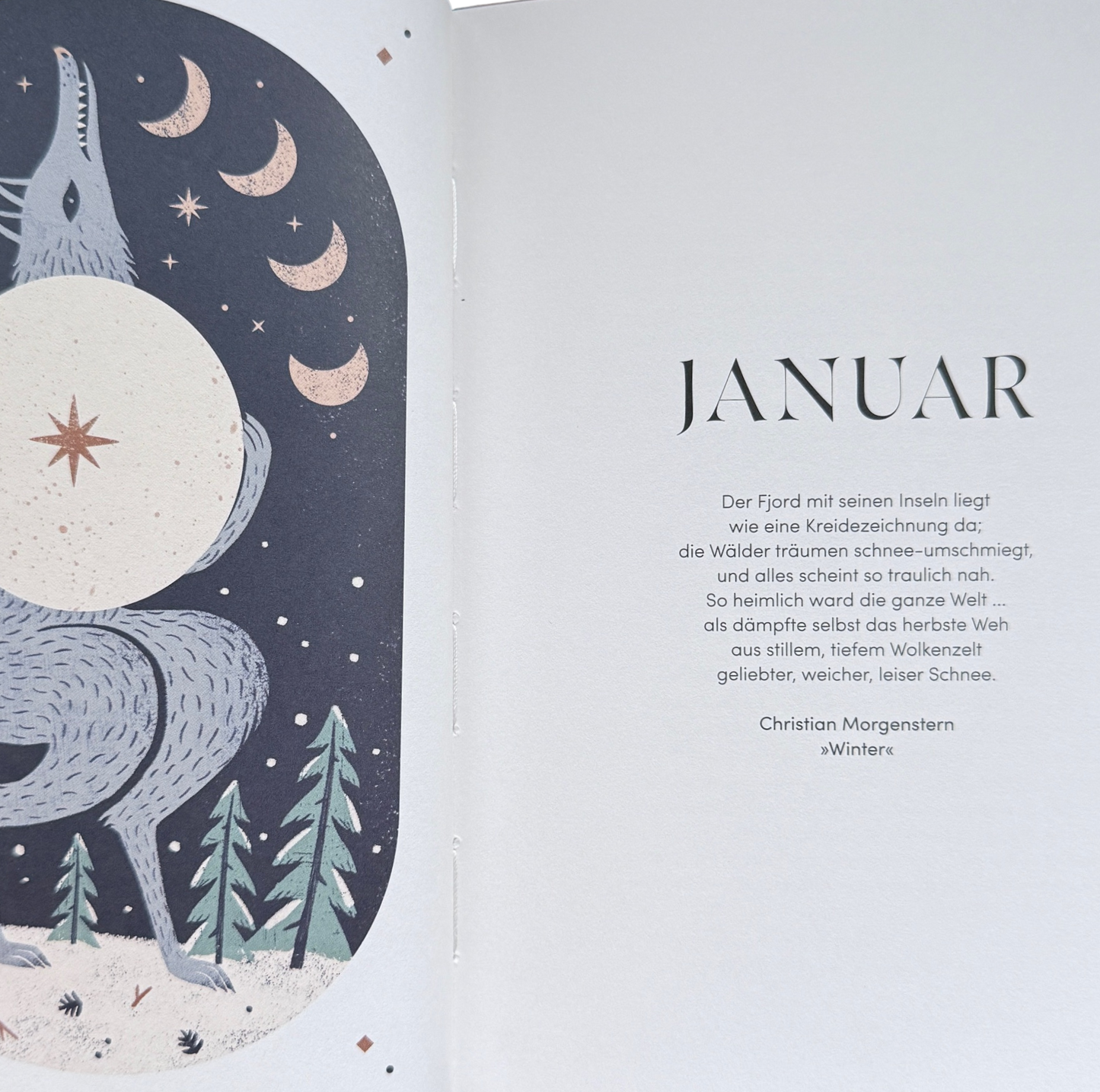 Eine Buchseite. Der Januar mit einem Wolf als Symbol für den Wolfsmond im Januar.