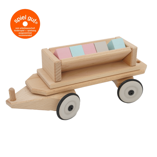 Eine Lore zum Kippen aus Buchenholz mit bunten Bausteinen. Ein Eisenbahnanhänger.