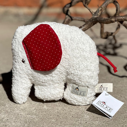 weißer elefant greifling fuer babys mit roten ohren mit weißen punkten aus baumwollfrottee