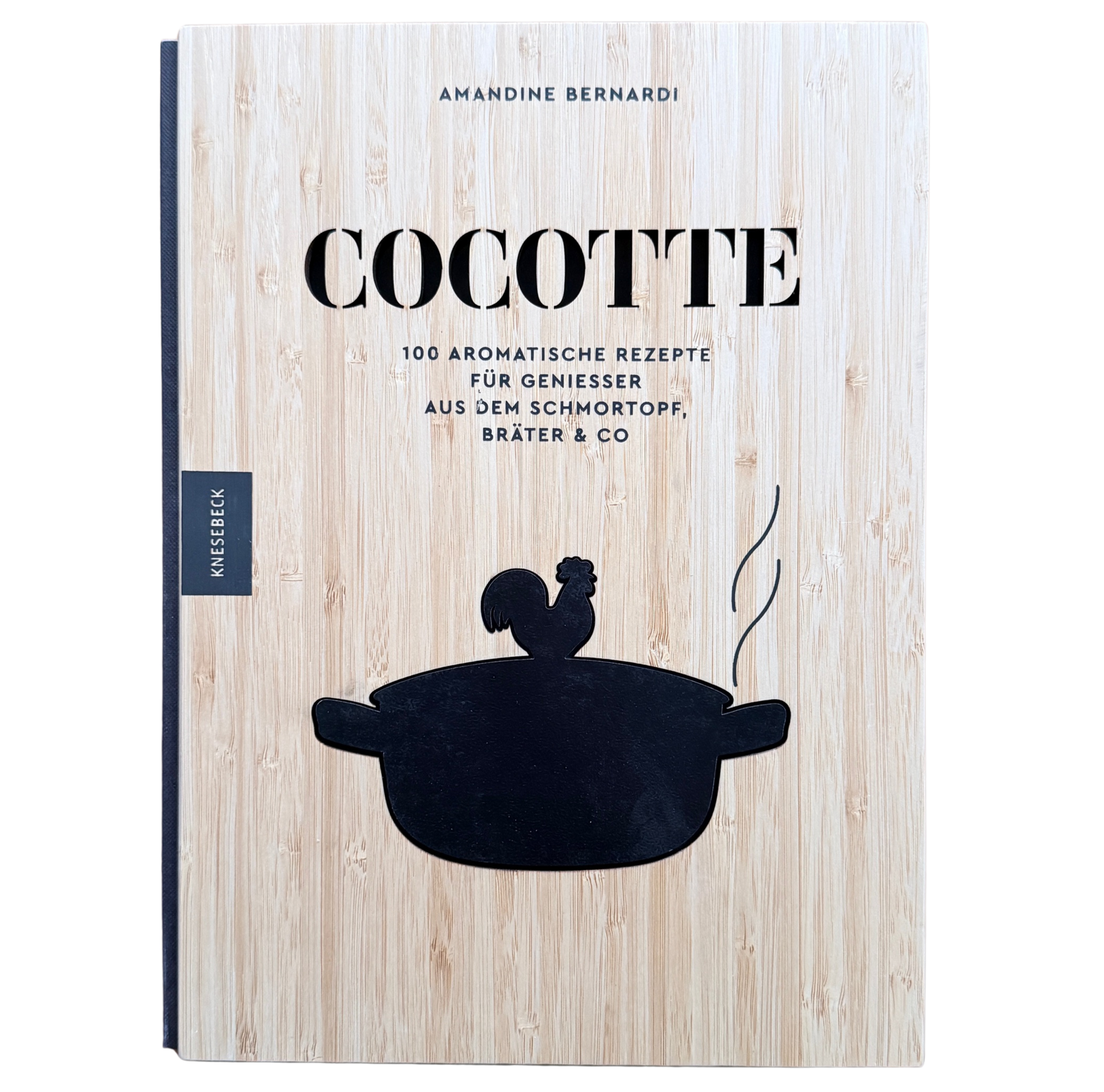 Kochbuch mit Schmortopfgerichten mit einem Holzeinband und einem schwarzen Schmortopf auf den Cover. 