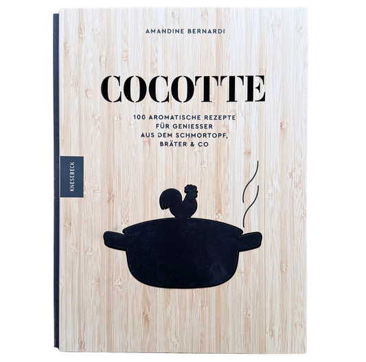 Kochbuch mit Schmortopfgerichten mit einem Holzeinband und einem schwarzen Schmortopf auf den Cover. 