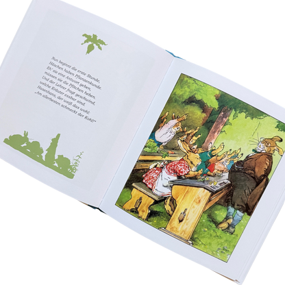 Eine Buchseite von die Häschenschule mit dem Hasenlehrer vor den Schulbänken mit den Hasenschülern beim Melden.