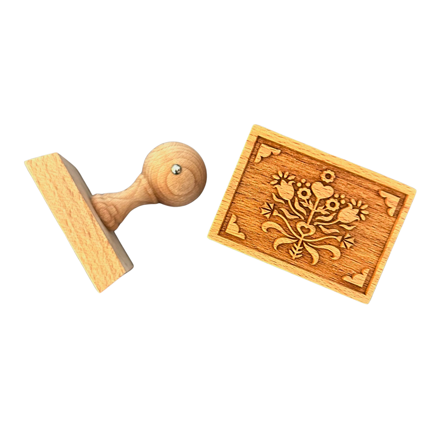 Ein Keksstempel aus Holz mit Blumenstraußmotiv.