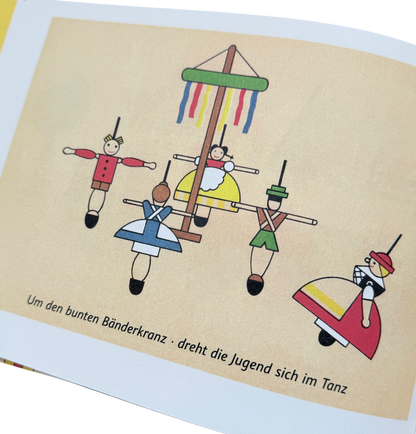Kinderbuch - das bunte Spielzeugdorf - Seite mit erzgebirgischen Spielsachen. Bunte Kreisel.