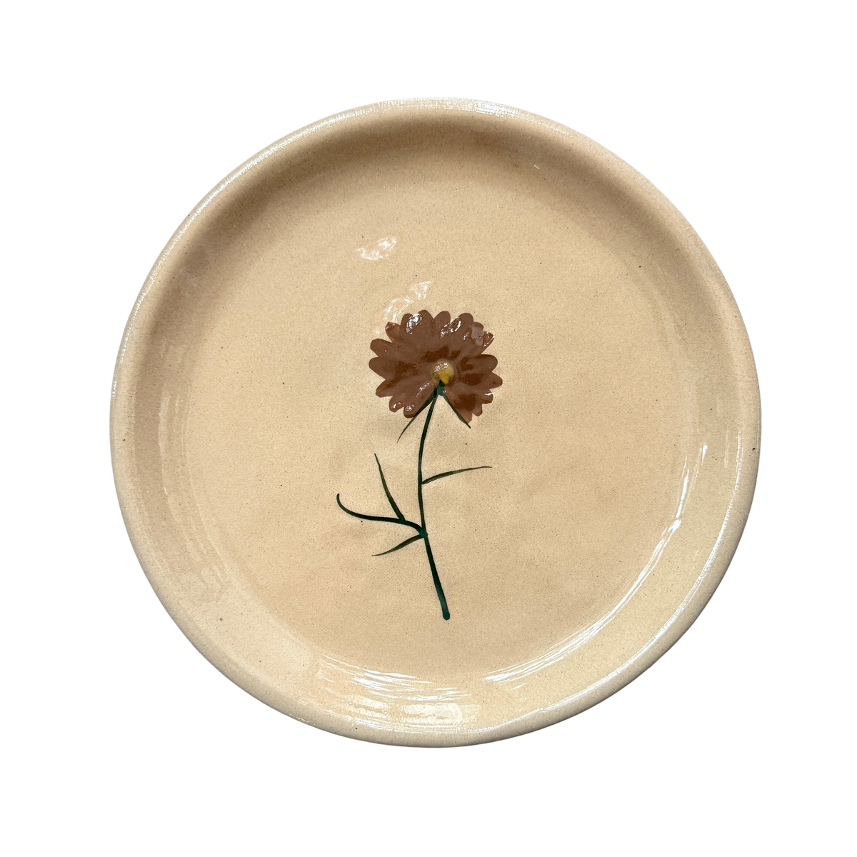 Kleiner Dekoteller in Puderrosa mit einer kleinen Blume als Dekor. 
