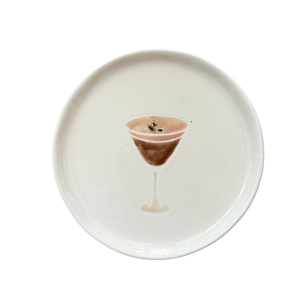 Kleiner Teller in Beige mit einem Glas Martini-Espresso als Dekor. 