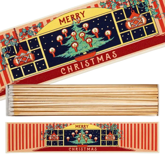 Lange Streichhölzer in einer Schachtel mit Vintage Stil mit einem geschmückten Tannenbaum. 